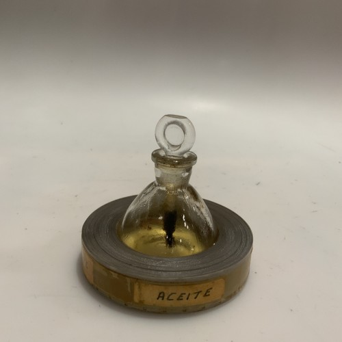 Frasco de aceite técnico cinematográfico con base de película