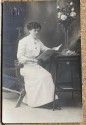 Photography lady leaning on table reading Coyne